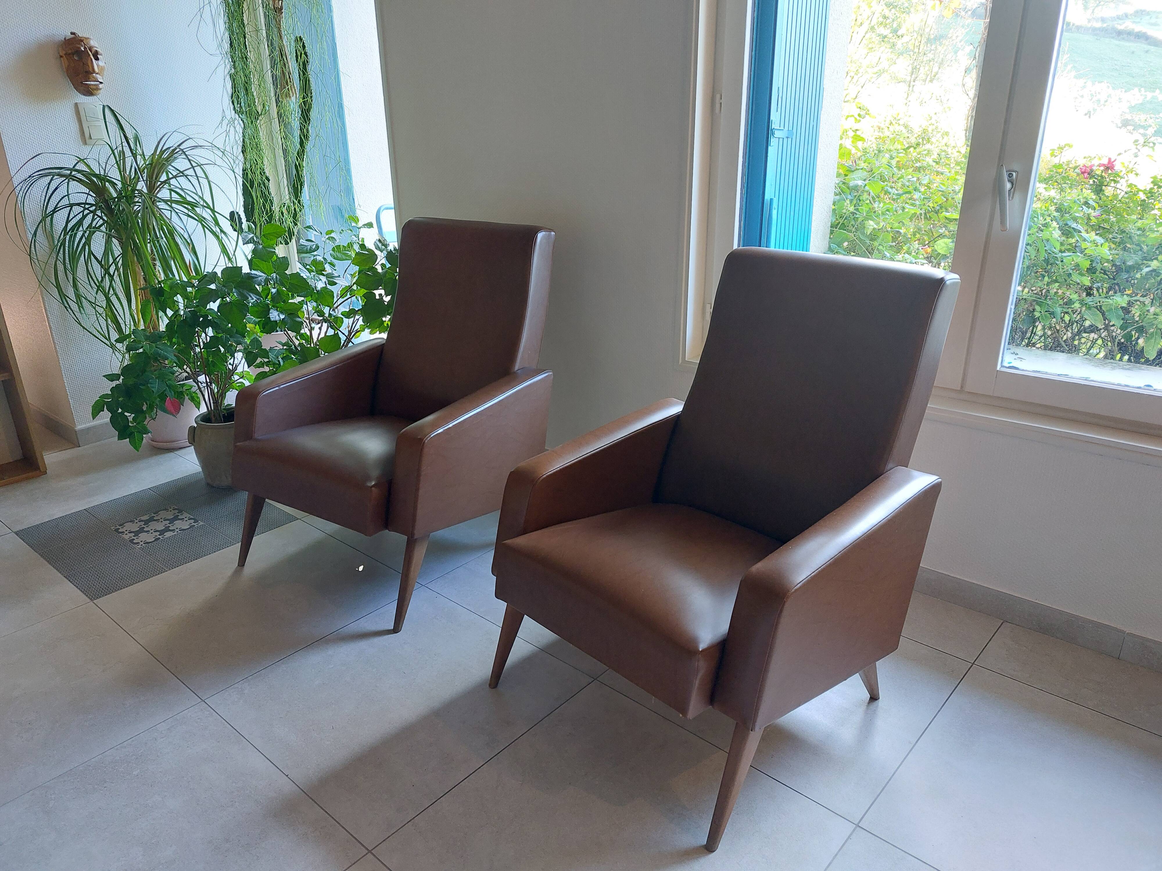 a pair of comfortable vintage armchairs with splayed legs