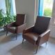 a pair of comfortable vintage armchairs with splayed legs