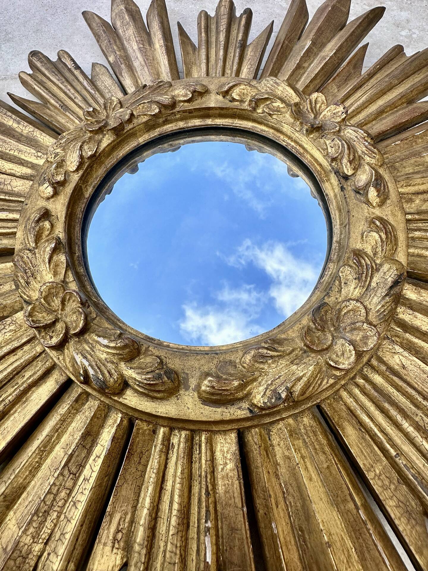 Large sun mirror in carved gilded wood.