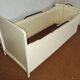 Painted wooden child's bed.