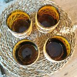 4 amber glasses and wicker 1970
