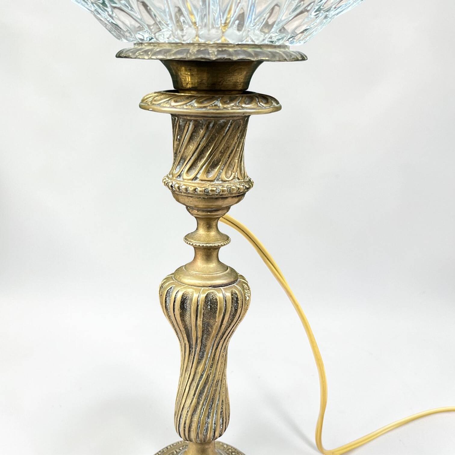 Antique brass foot lamp with glass globe and diamond point.