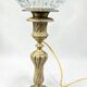 Antique brass foot lamp with glass globe and diamond point.