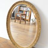 Beveled oval mirror and gilded wood frame