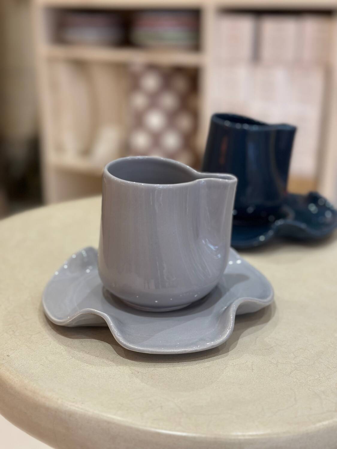 Set of ceramic artisan mugs with blue-grey pop water lily design.