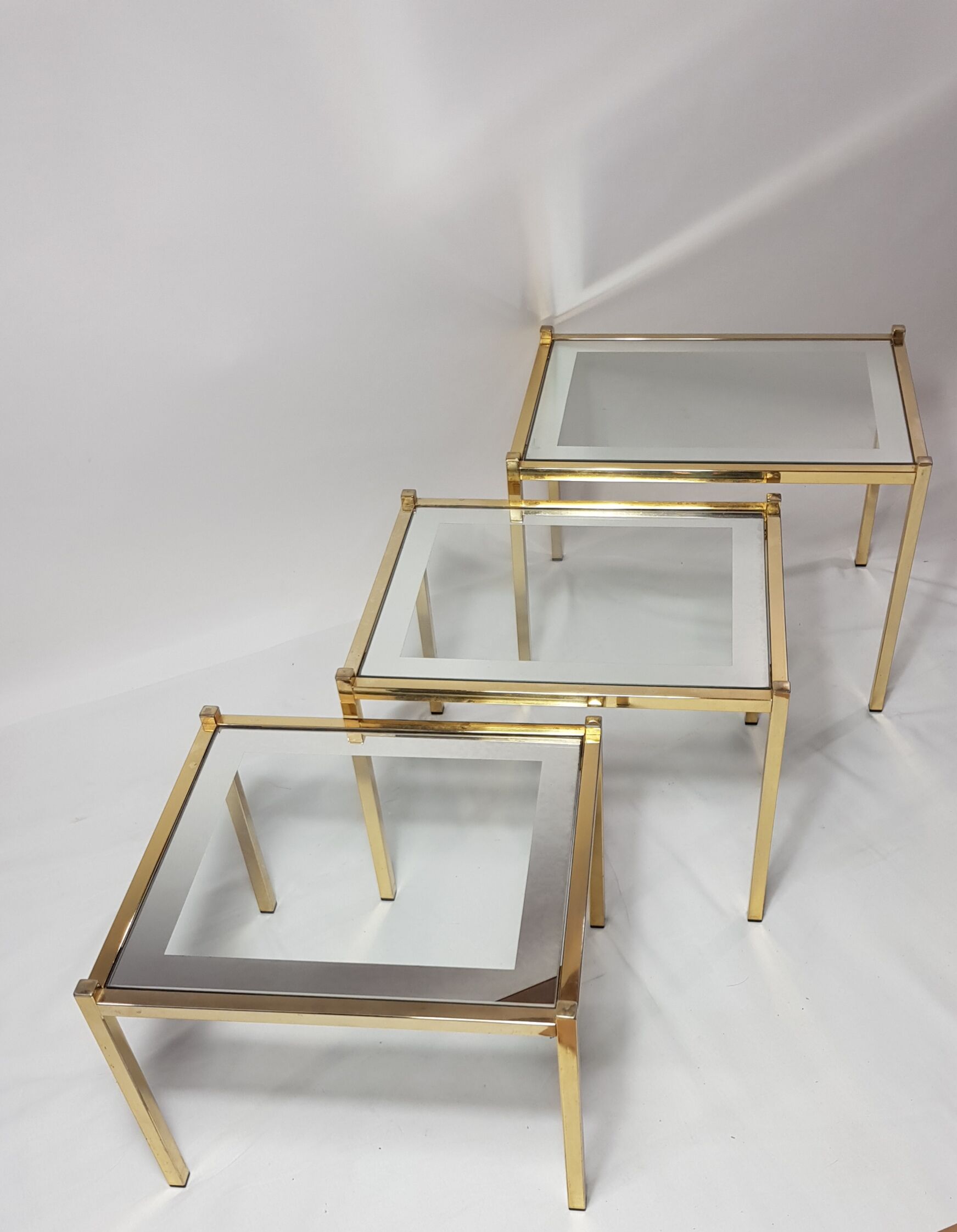 Three trundle tables gilded brass and silver 60s