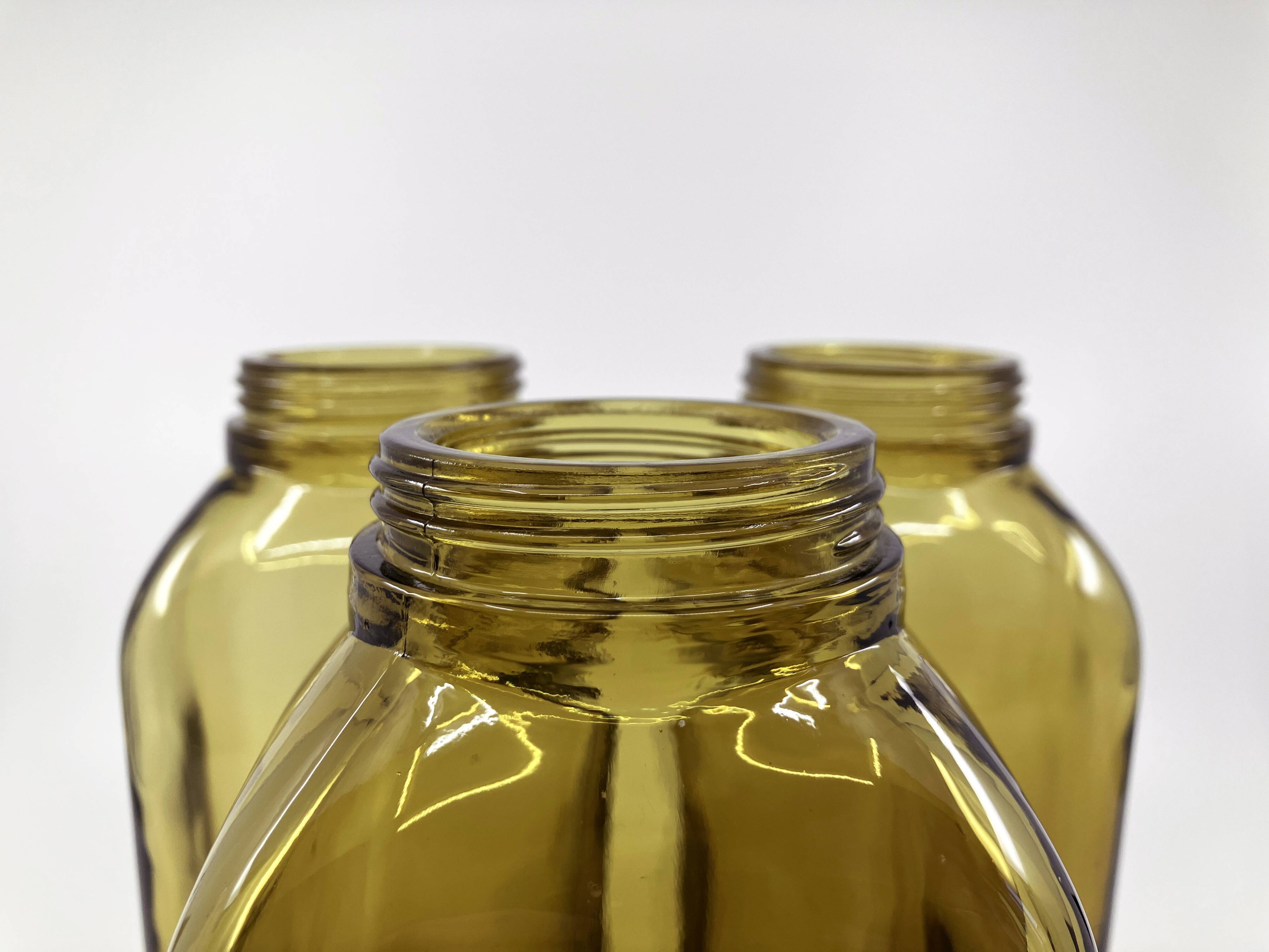 3 molded amber glass pharmacy bottles • Bakelite stoppers • 1950