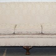 Victorian suite in damask, walnut frame, legs carved in lion's paw.