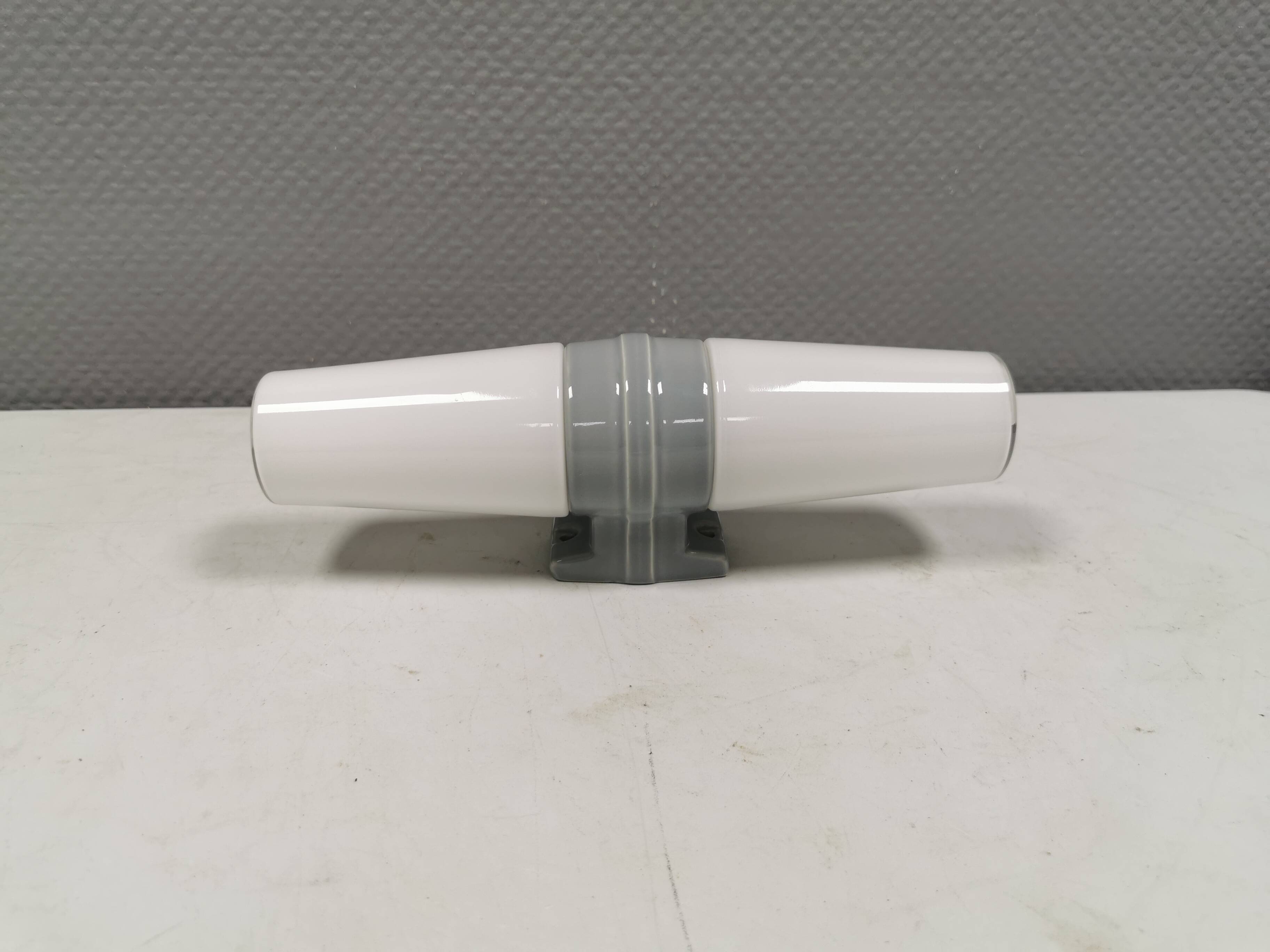 Bathroom lamp with light gray ceramic base,  and milky white opal glass.