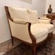 Two-seater canapé by Roche Bobois in Louis XVI style — carved wood, caned sides.