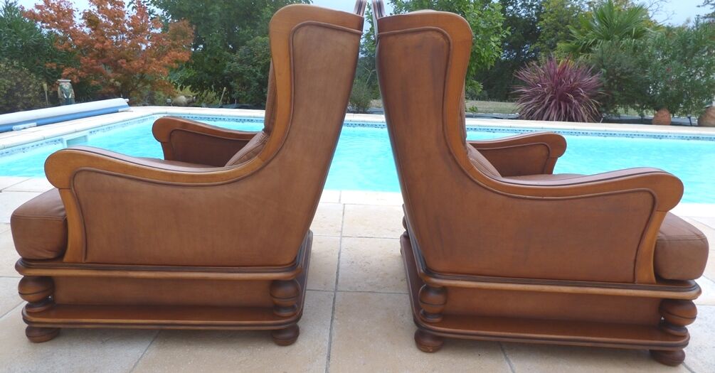 Pair of aged leather armchairs with seat and firm backrest with cherry wood frame