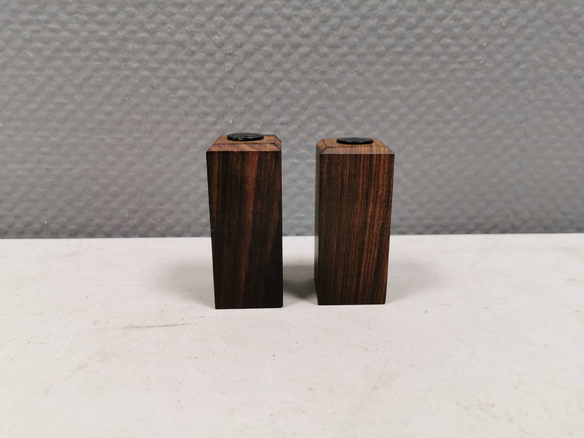 A set of salt and pepper shakers in rosewood