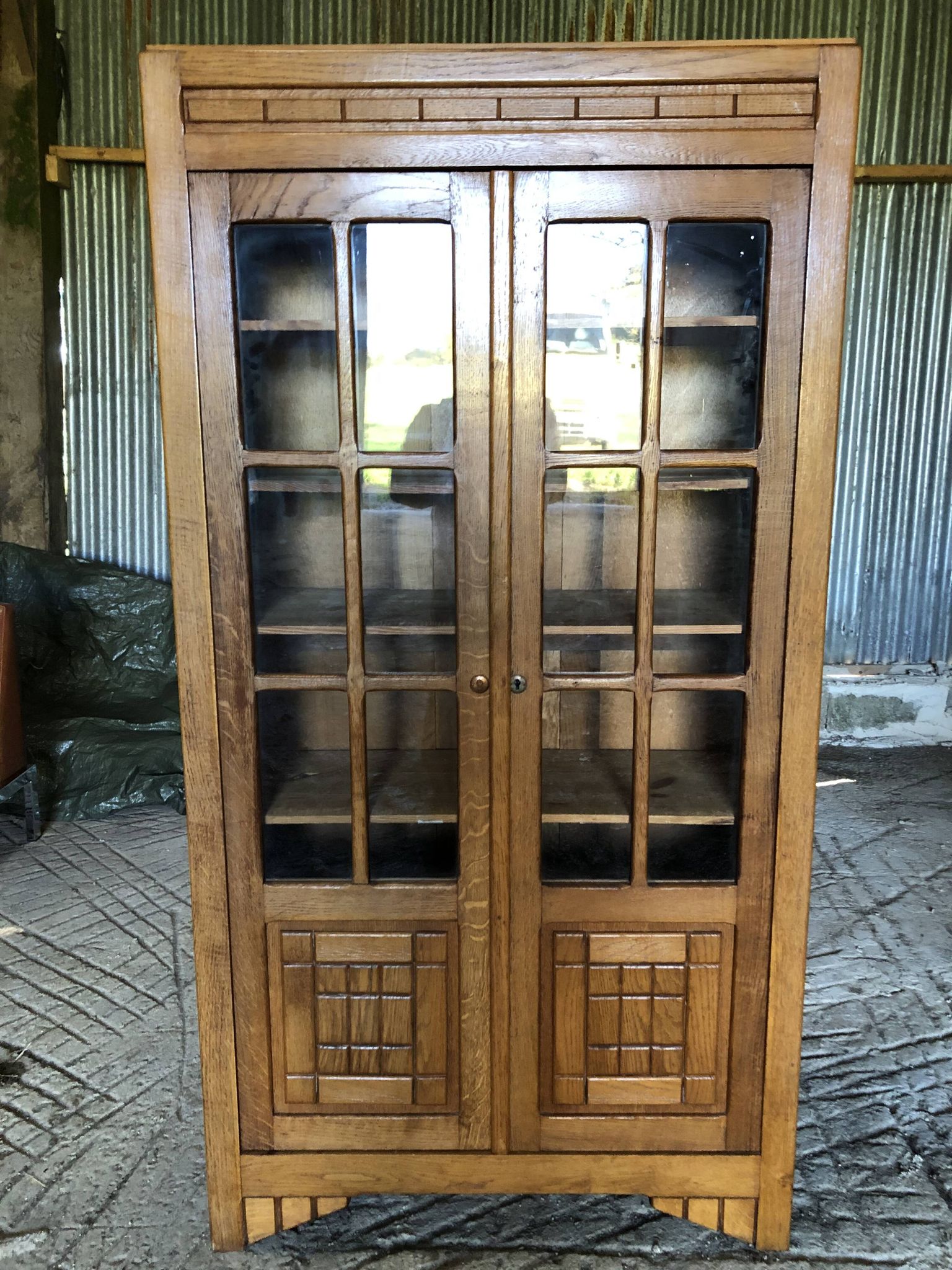 Vintage oak bookcase from the reconstruction period with 2 doors with small panes.