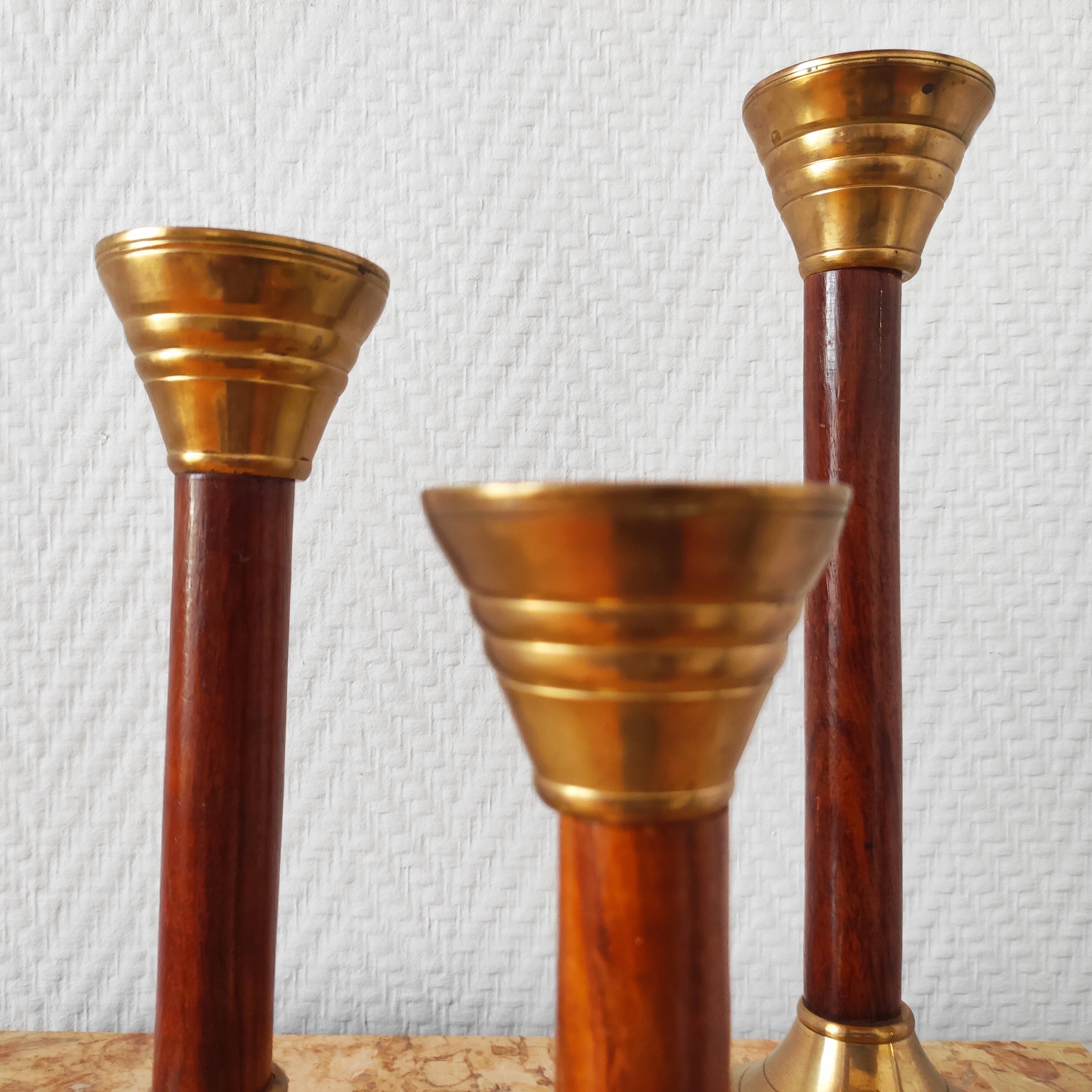 Set of three vintage wooden and brass candlesticks
