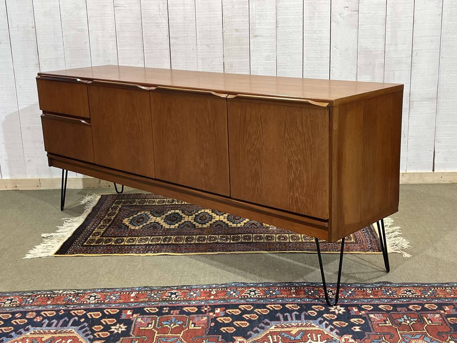 1970s English enfilade in teak with splayed legs.