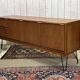 1970s English enfilade in teak with splayed legs.