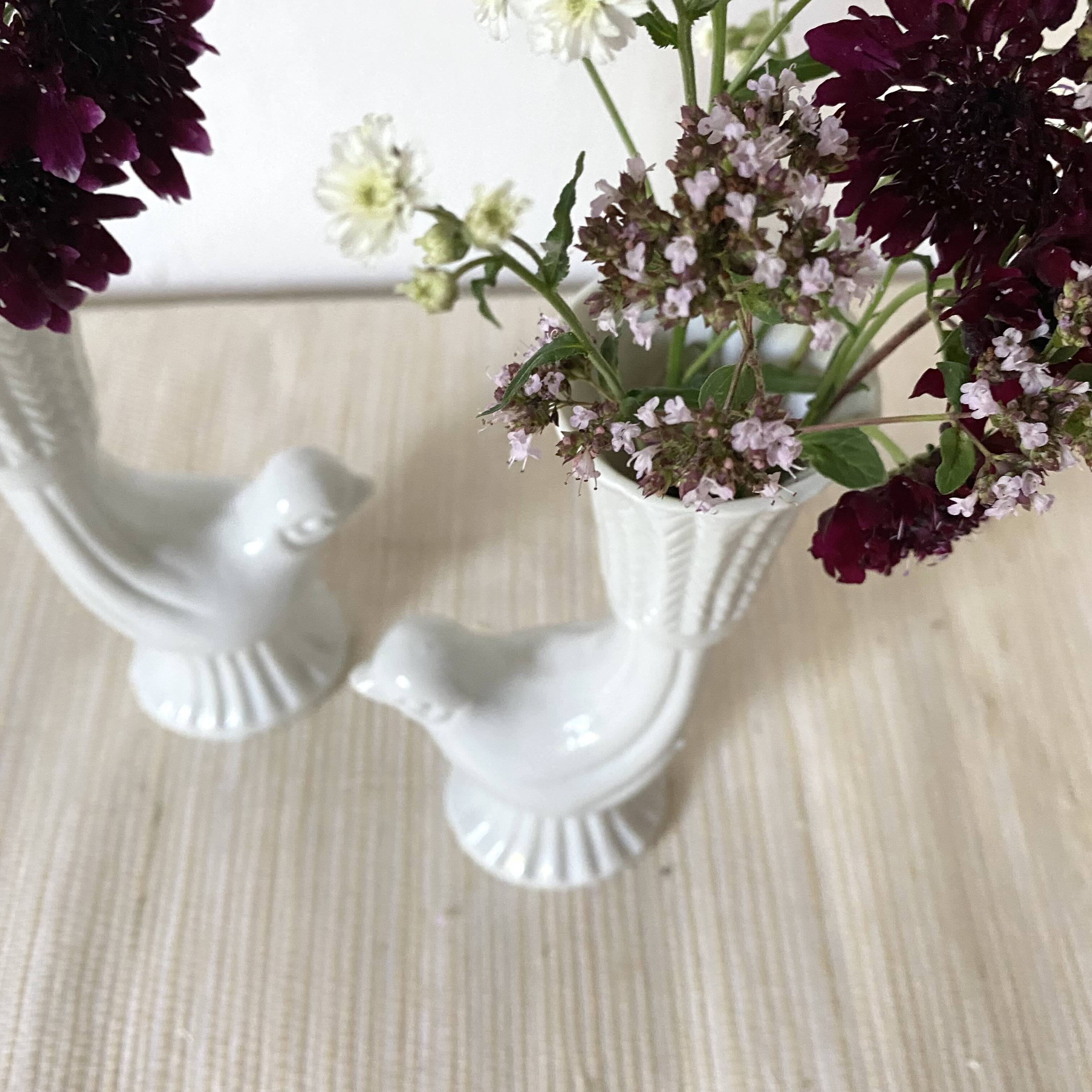 Pair of porcelain candle holders and bird vases