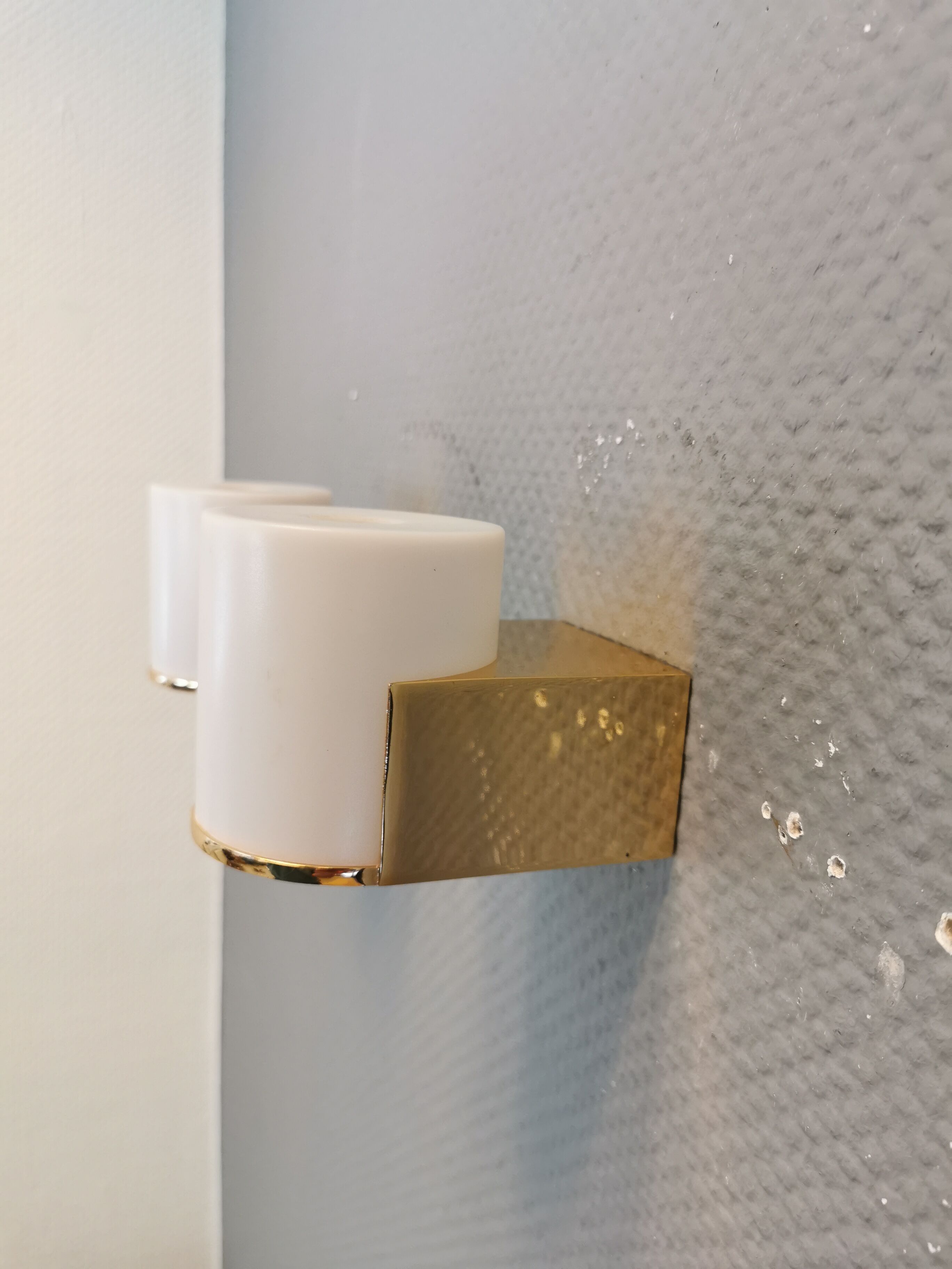 Wall lamps with milky white acrylic plastic shades and solid brass bases