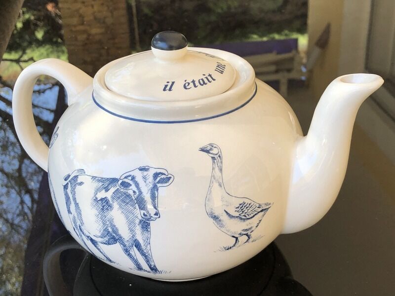 White porcelain teapot decorated with animals
