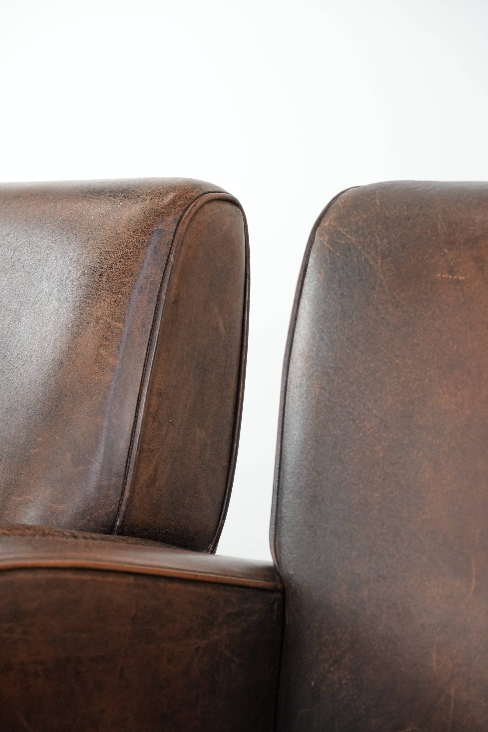 Set of two vintage sheepskin leather design armchairs in a cognac colour