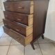 Vintage chest of drawers from the 1950s with wooden legs and a design feature.