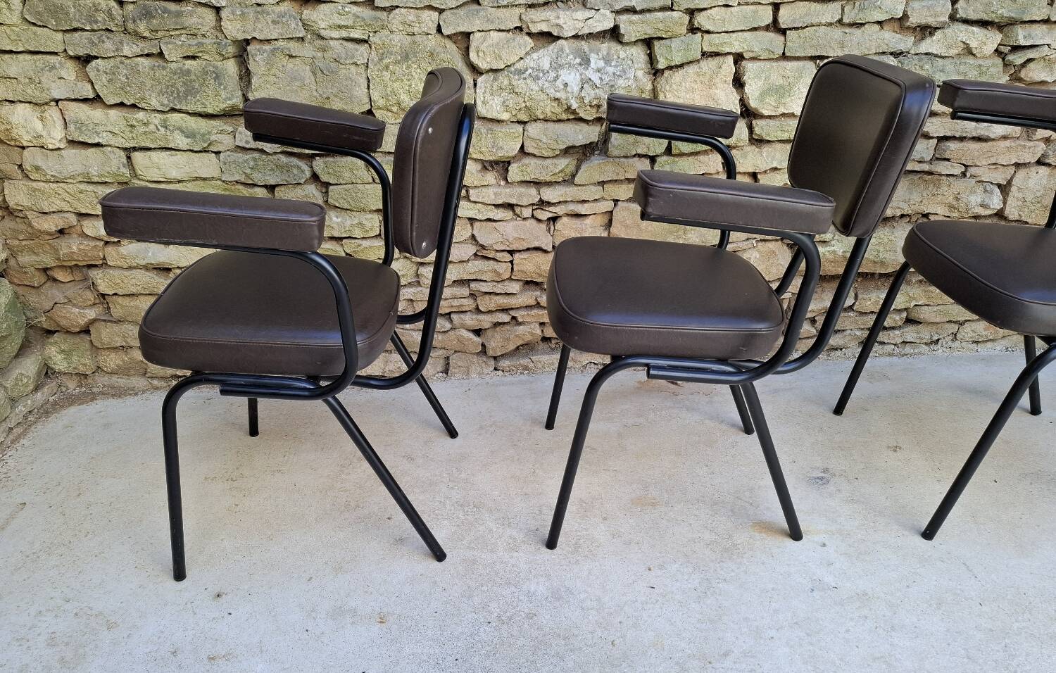 Brown faux leather armchairs