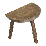 Half-moon tripod stool.