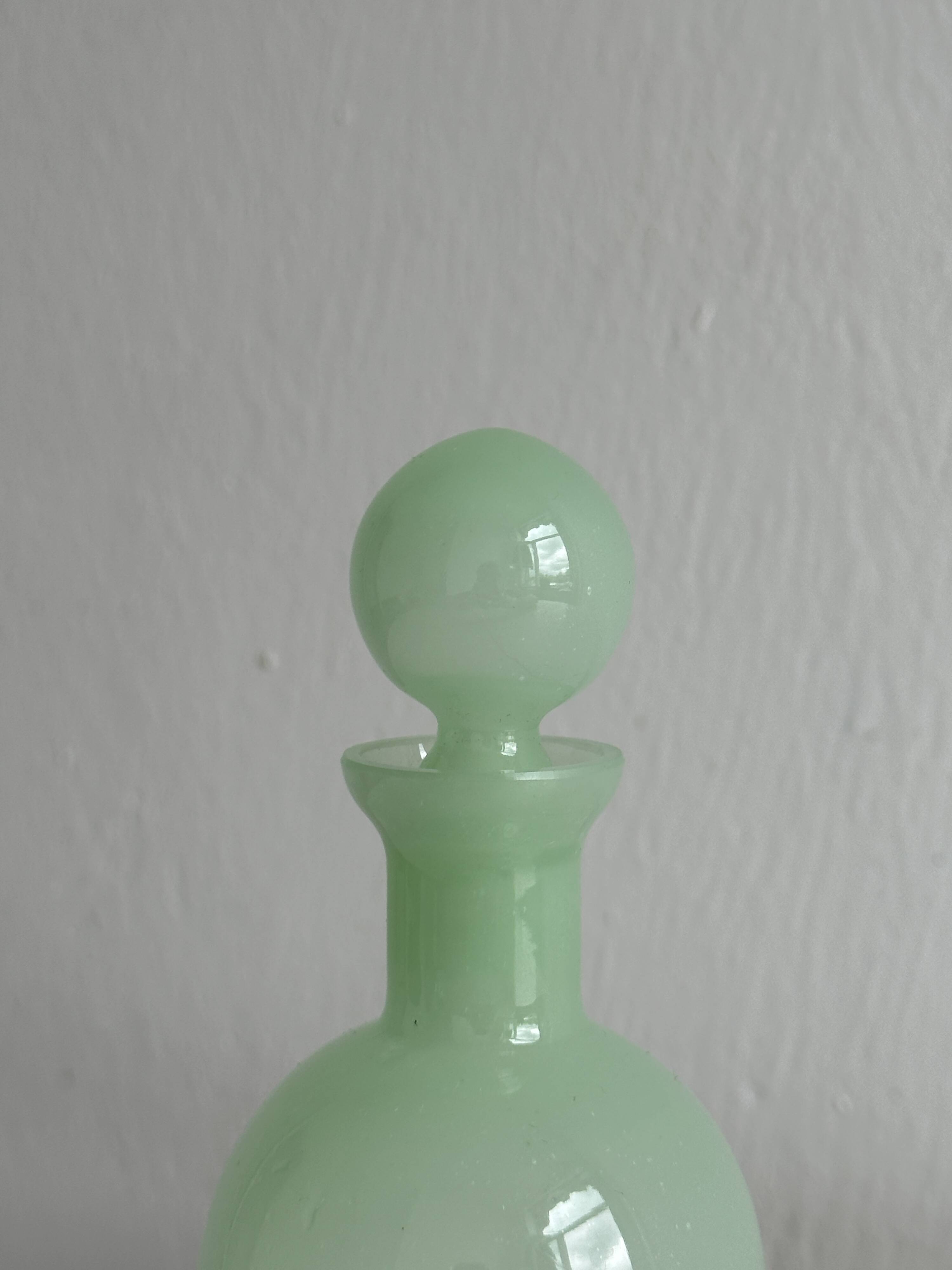 Opaque light green glass vial