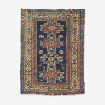 Handwoven blue ground persian rug with bird-like figures