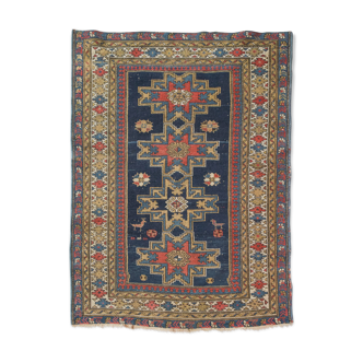 Handwoven blue ground persian rug with bird-like figures