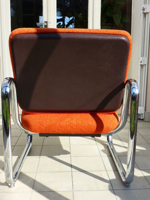 The 1970s orange armchair fabric and chrome metal