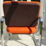 The 1970s orange armchair fabric and chrome metal