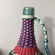 Old glass bottle and vintage scoubidou plastic weaving
