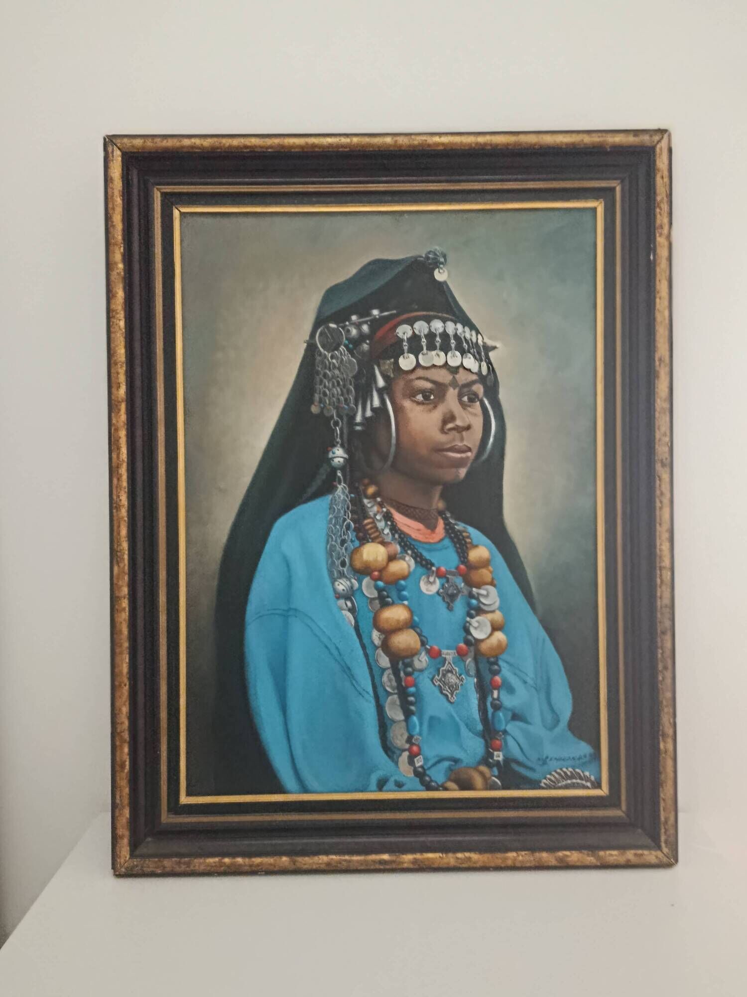 Portrait of a young Moroccan woman in traditional attire and adornments.