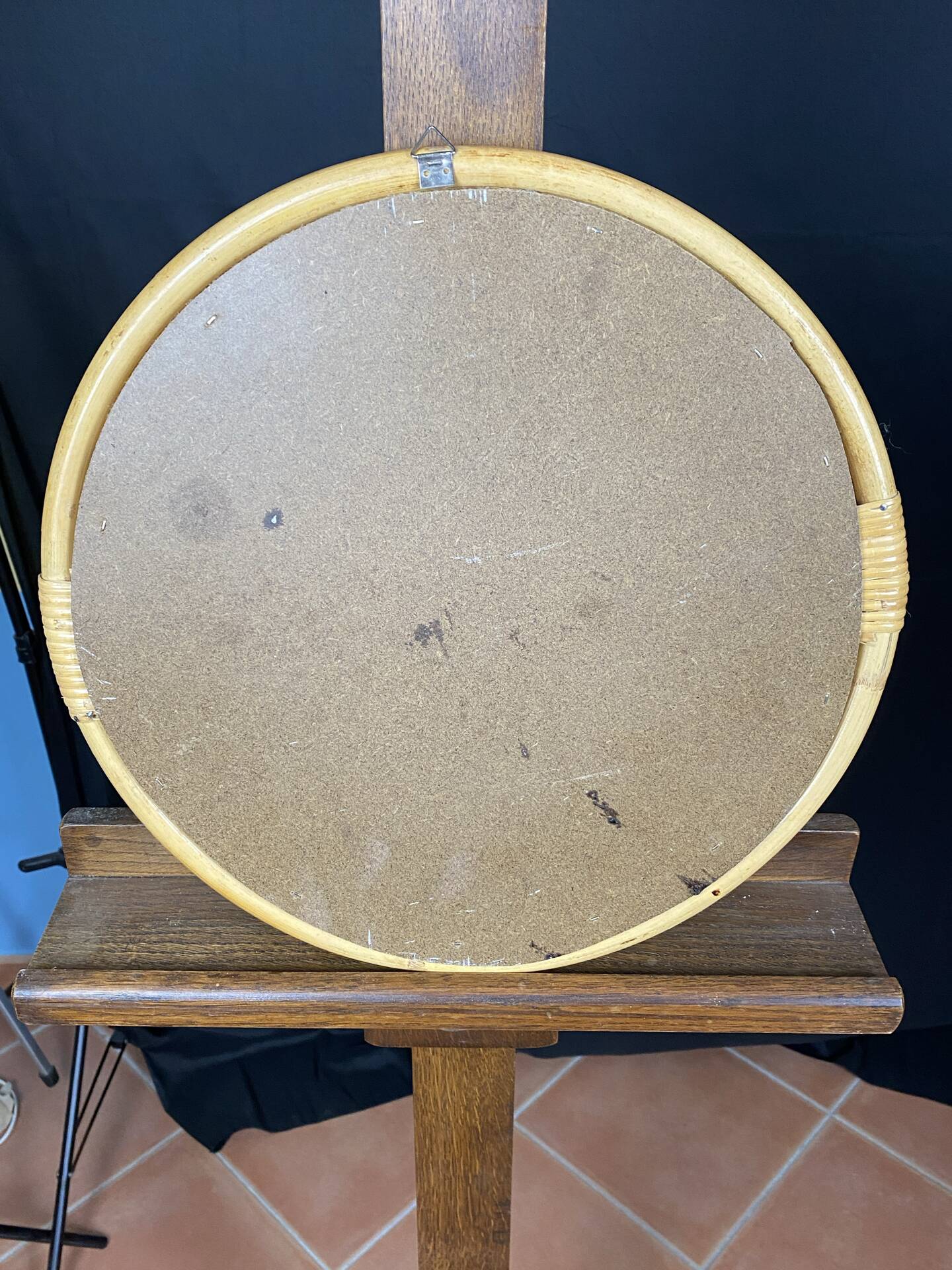 Round mirror from the 1960s with a frame made of rattan and metal.