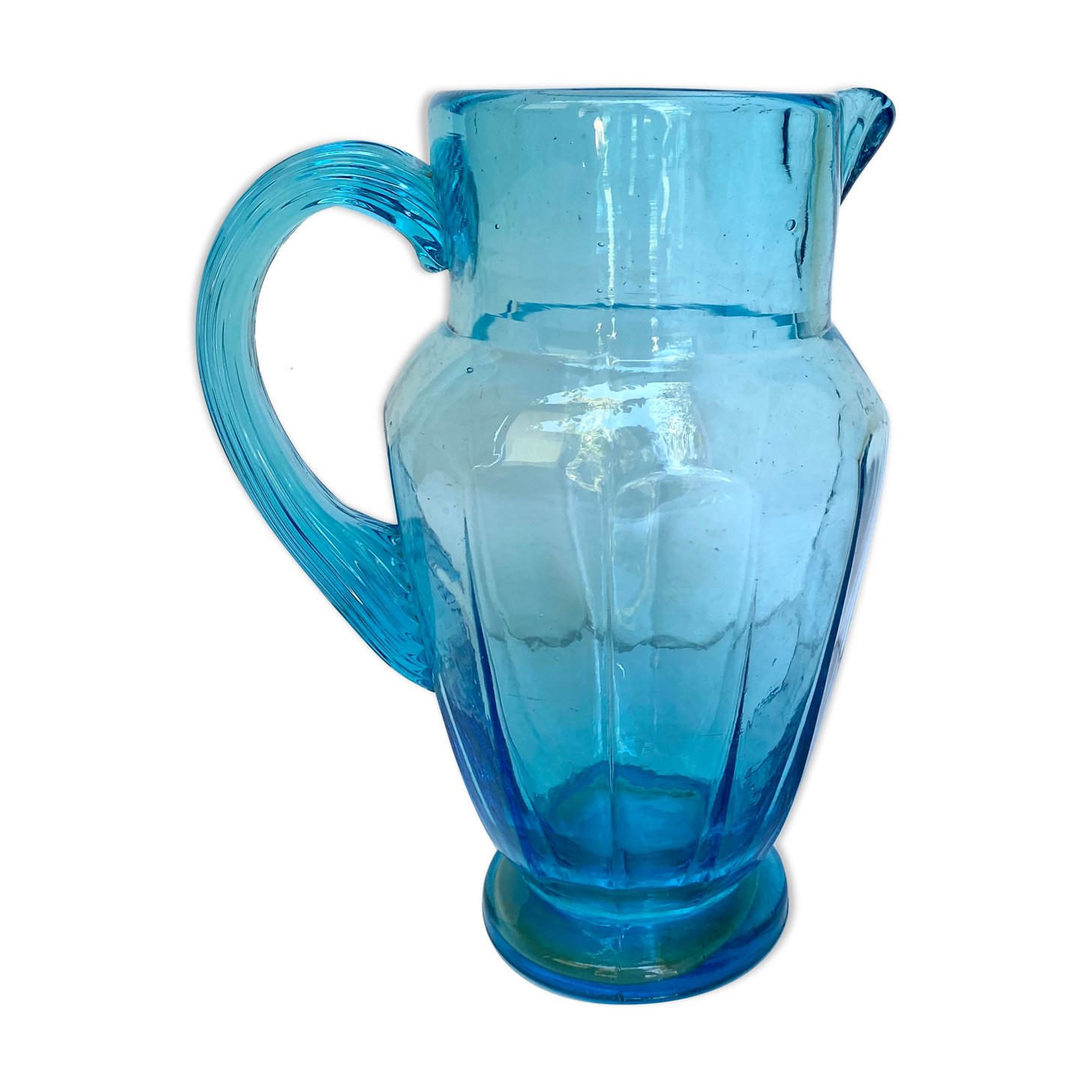 Old pitcher in blue glass
