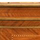 In-between furniture in marquetry decorated with a trophy decoration of musical instruments