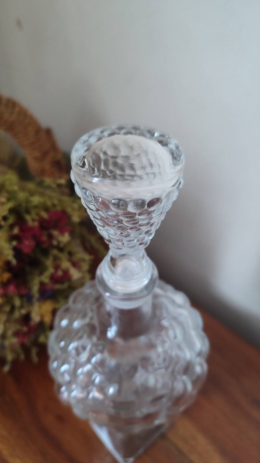 Pressed glass carafe in the shape of a bunch of grapes.