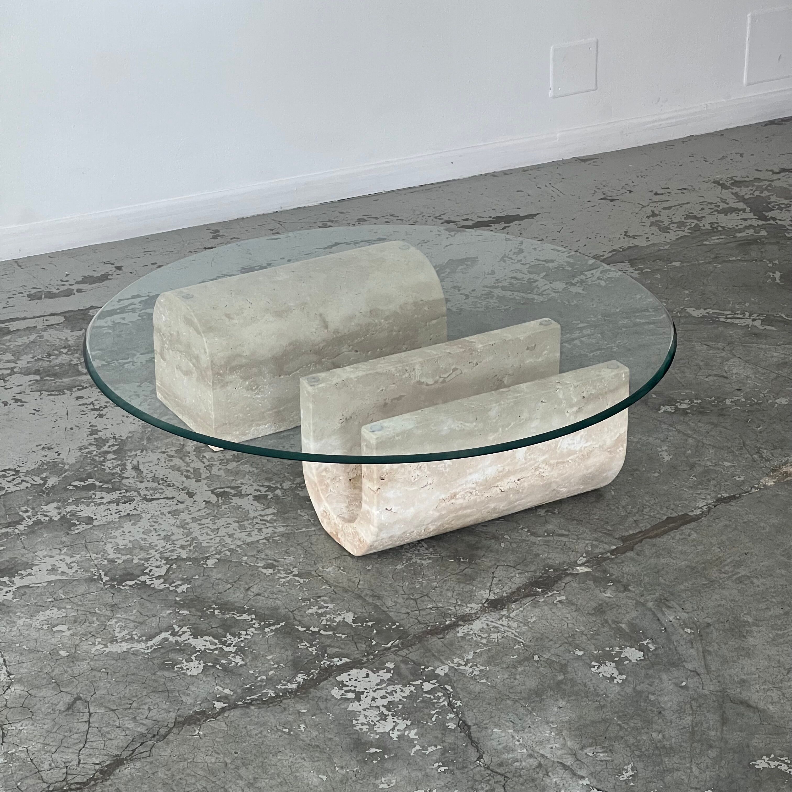 Coffee table in travertine and glass