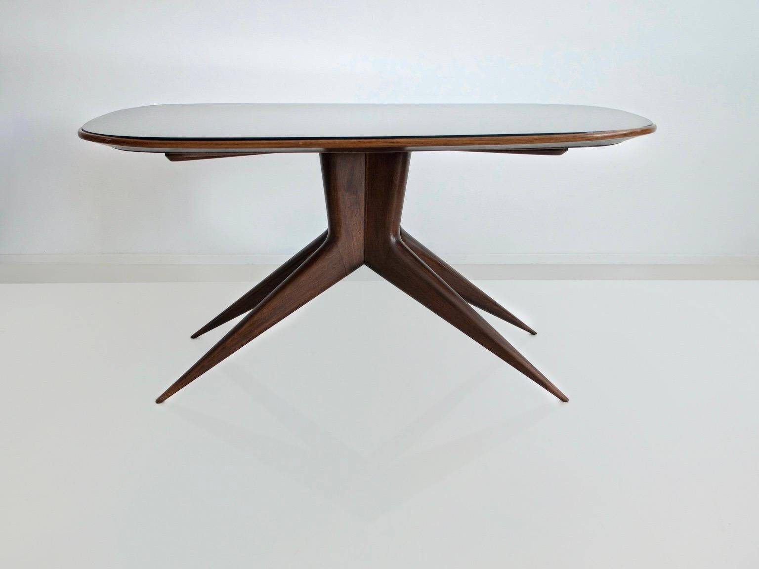 Dining table with a wooden frame and tinted glass top.
