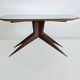 Dining table with a wooden frame and tinted glass top.