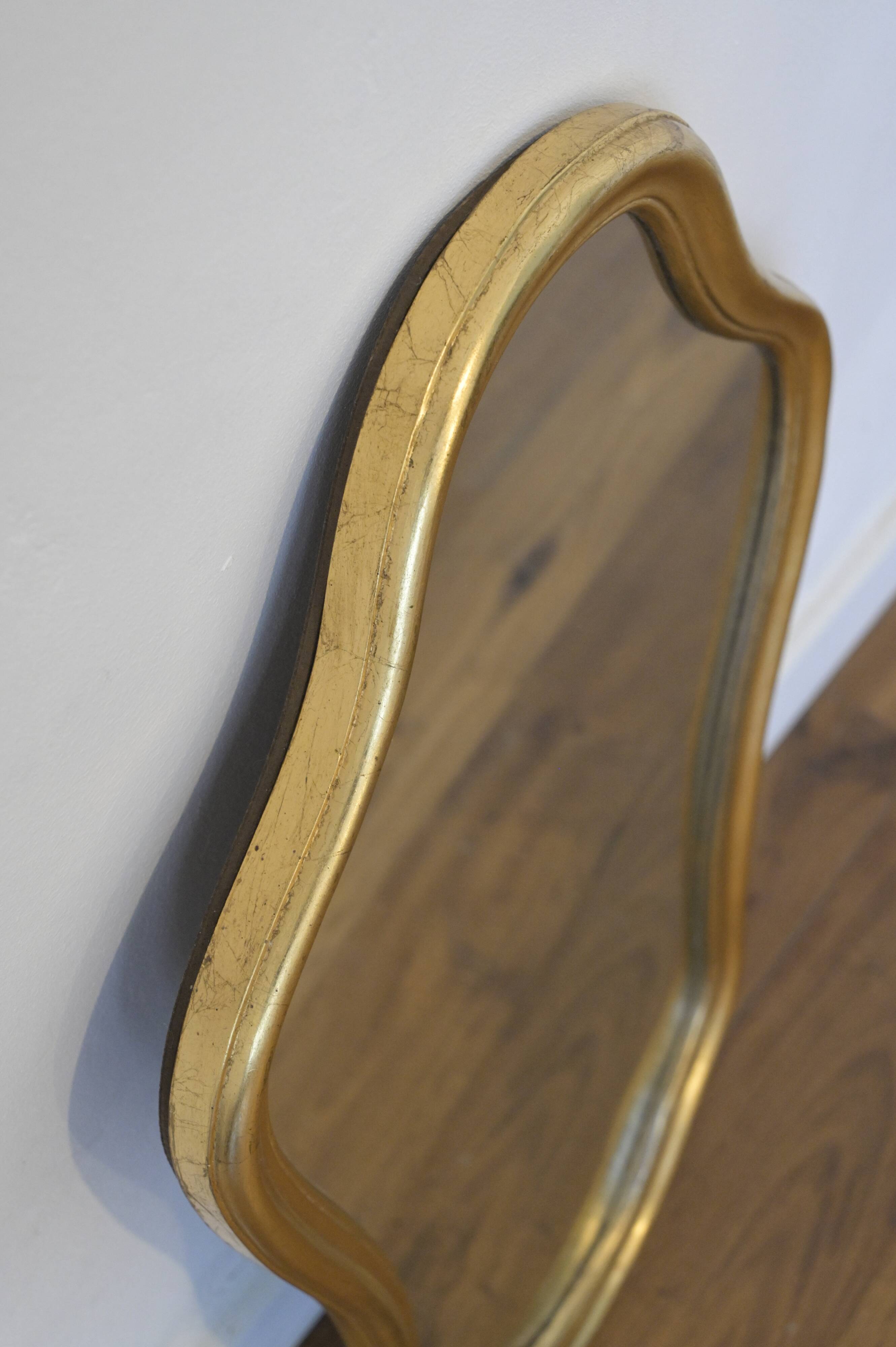 Golden mirror in wood and gold leaf