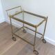 Neoclassical brass trolley with removable trays.