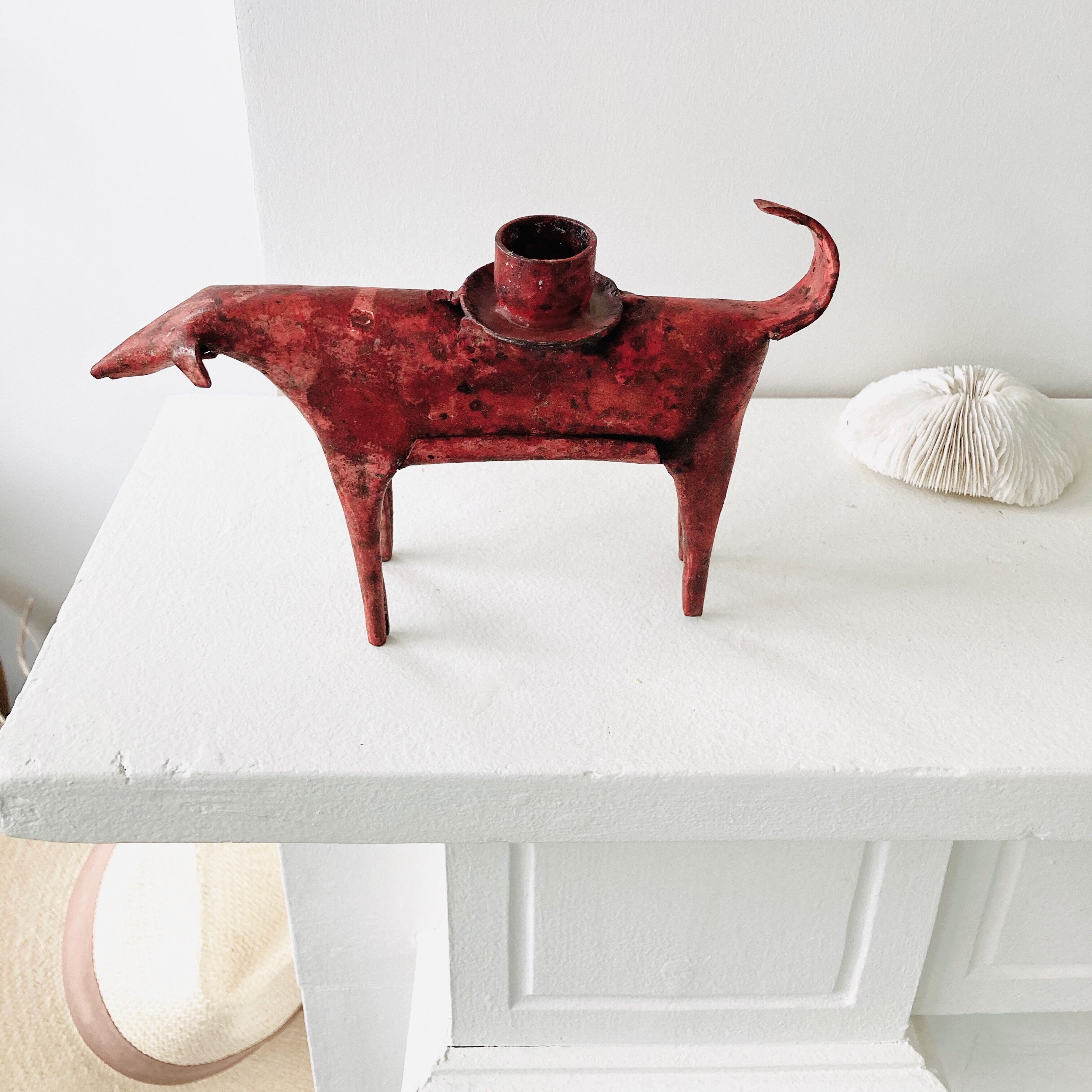 Zoomorphic candlestick made of red metal