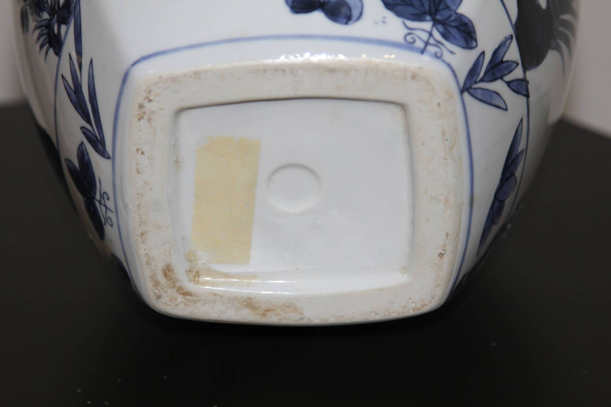 A pair of Chinese blue and white ovoid vases and flush-fitting circular covers