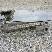 Oval coffee table of the 70s chromed metal base in s smoked glass top
