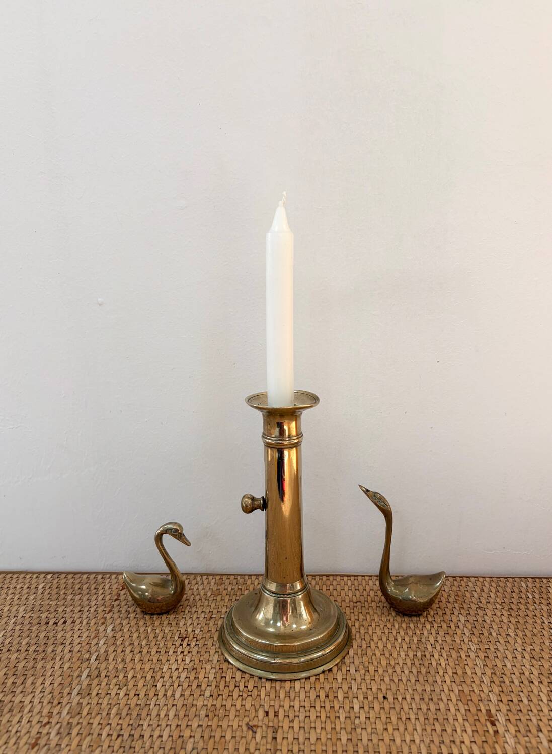 Old brass candlestick with push button.
