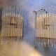 Pair of wall lights with hanging glass pendants in gold color