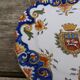 Assiette XVIII eme chantournée  en faience de  Rouen avec blason et motifs floraux