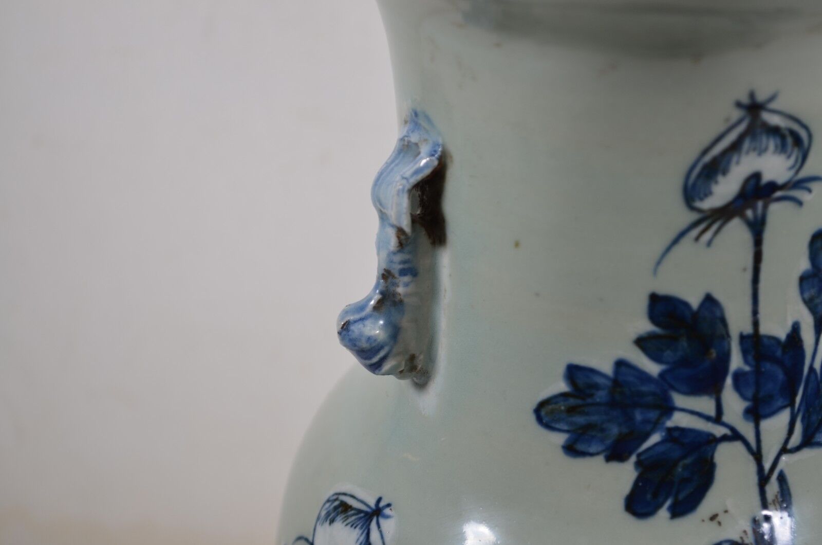 China. Porcelain mallet vase with blue and white phoenix decoration on a rock.